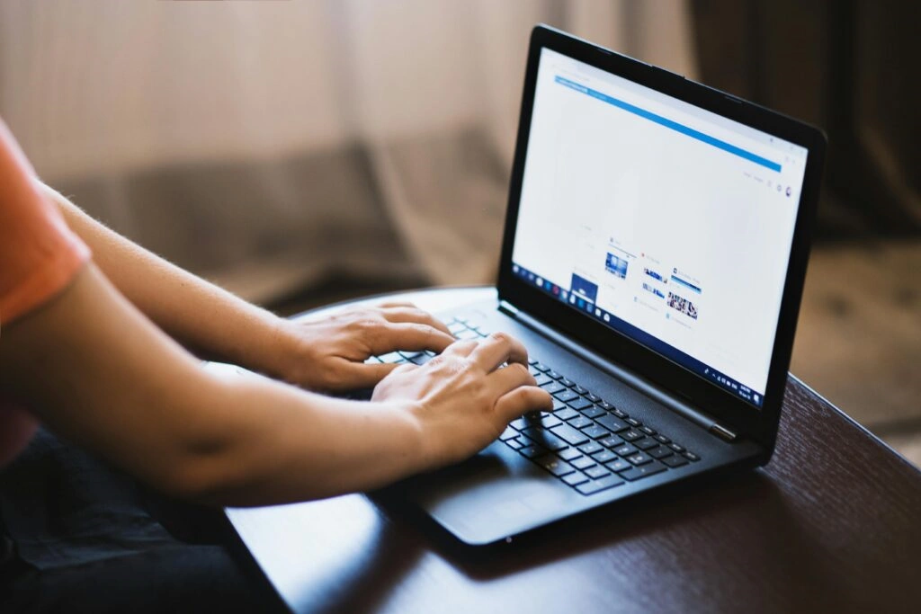 Person typing on laptop - Mastering SEO